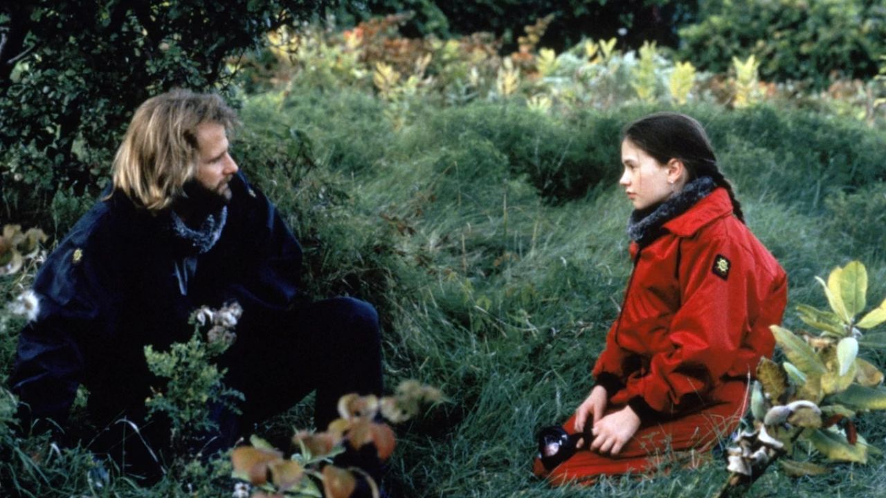 a man with a beard talking to a girl